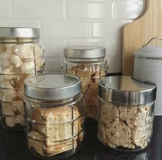 several jars filled with food sitting on top of a counter