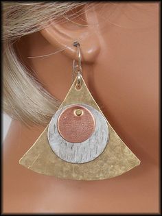 NEW! Wear with everything! Hand cut from bronze, pewter and copper sheet. Textured with hammers and riveted. Widest part of earring is about 2 inches. Earrings hang from handforged sterling french wires and are about 2 1/4 inches in length. Modern Pyramid, Hammered Metal Jewelry, Rivet Jewelry, Metalwork Jewelry, Metalsmithing Jewelry, Mixed Metal Jewelry, Fine Silver Jewelry, Silver Earrings Handmade, Earrings Inspiration