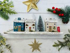 a shelf with christmas decorations on top of it and a star hanging from the ceiling