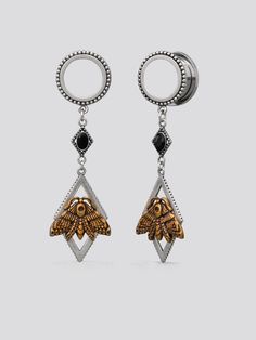 two tone gold and silver earrings with an insect on the front, hanging from a circular hoop