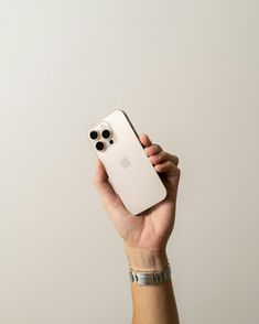 a person holding an iphone in their hand with the camera on it's side