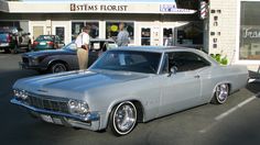 an old car parked in front of a store