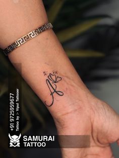 a small tattoo on the wrist of a woman