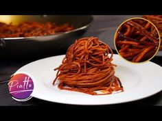 some food is on a white plate next to a frying pan and silverware