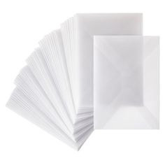 white envelopes are stacked on top of each other in front of a white background