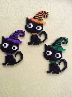 three black cats with halloween hats on their heads are made out of perler beads