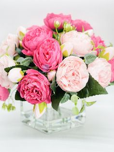 a vase filled with pink flowers on top of a table