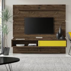 a living room scene with focus on the entertainment center and television mounted to the wall