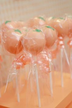 some lollipops with green leaves on them are sitting on a table and ready to be eaten