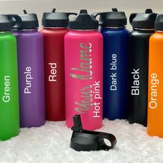 six different colored water bottles sitting in the snow next to each other with their names printed on them