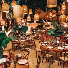 a restaurant with tables, chairs and hanging lights