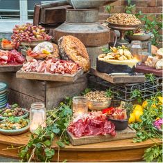 an assortment of meats and cheeses on display in front of a brick building