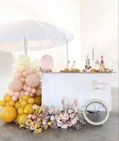 an ice cream cart decorated with balloons and flowers