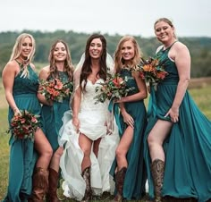 a group of women standing next to each other on top of a grass covered field