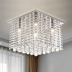 a chandelier hanging from the ceiling in a living room