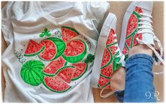 a woman's feet wearing white sneakers with watermelon slices on them, and a t - shirt that says go green