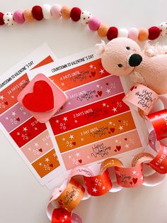 a valentine's day sticker with a teddy bear on it next to some hearts