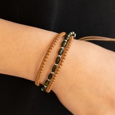 a close up of a person's arm wearing a bracelet with beads on it