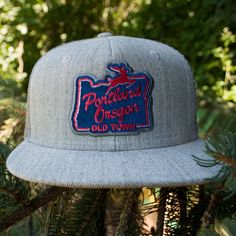 Your visit to Portland isn't complete without a glimpse of this (officially) historic Oregon landmark. Didn't get a good pic due to the pouring rain? No worries...take it home on a hat! Grey wool front with grey mesh back; 100% embroidered patch. The 6-panel twill flat billed trucker hat is a constructed, 6-panel hat featuring insulated rear mesh panels and a retro flat bill. Comes with a vintage plastic snap closure. Plastic snap closure Flat billed 6-Panel, Constructed Cooling polyester mesh s Vintage Flat Bill Snapback Hat For Outdoor, Vintage Snapback Hat With Flat Bill For Outdoor, Vintage Snapback Hat With Flat Bill For Outdoor Activities, Vintage Trucker Hat For Outdoor Activities, Vintage Cap For Outdoor Activities, Vintage Flat Bill Baseball Cap For Outdoor Activities, Vintage Snapback Hat For Outdoor Activities, Vintage Snapback Baseball Cap For Outdoor Activities, Retro Fitted Hat With Flat Bill For Outdoor