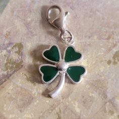 This is a vintage, Lillian Vernon, sterling silver and green enamel, 4 leaf clover or shamrock, Saint Patrick's Day, charm or pendant with a lobster claw clasp. It has tested positive for sterling silver. All sales are final. This measures 1.5 inches in length, including the lobster claw clasp. If you have a wish list or are looking for something specific, please ask. I may have exactly what you are looking for. As always please convo me with any questions or concerns regarding this item or with Nickel-free Green Charms For Gifts, Green Charms With Lobster Clasp For Gift, Sterling Silver Green Jewelry For Good Luck, Elegant Green Charms For Gifts, Green Sterling Silver Jewelry For Good Luck, Green Charms Jewelry For Good Luck, Green Enamel Charm Jewelry, Green Enamel Jewelry With Charms, Green Nickel-free Collectible Jewelry