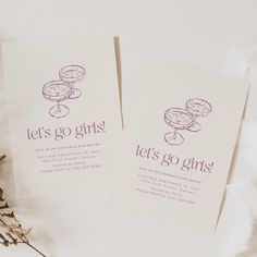 two cards with the words let's go girls on them next to dried flowers