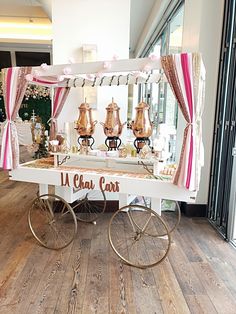 a table that has some kind of food on it with pink and gold decorations around it