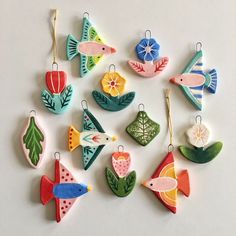 an assortment of ceramic ornaments on a white surface