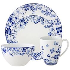 a blue and white dinnerware set on a white background