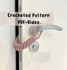 a crocheted pattern on the handle of a door with a hook attached to it