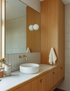 a bathroom sink sitting under a large mirror