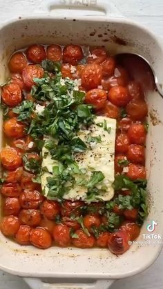 tomatoes and parsley in a white casserole dish