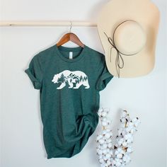 💗This Bear shirt is a perfect gift for everyone! Our shirts are made with the highest quality materials & are super soft, comfy & cozy! 💗 🟢 HOW TO ORDER 🟢 1. Check and Review ALL Photos 📷 2. Select Your T-Shirt Size and T-Shirt Color from drop down menus ✨ 3.Select Your Design Print Color from images and mention in personalization section 🎨 4. Add to cart & place order 🛒 We're constantly striving to provide excellent service. We'd love to get your feedback :) 🚚📦 SHIPPING & PRODUCTION Order Production: 1-2 days Your orders will be shipped within the production days and will arrive in timely manner ( Nation wide 2-5 days ) Satisfaction Guaranteed! 💚 We, Ojey Apparel, guarantee your satisfaction on every product we sell with a full refund. ✨ CARE INSTRUCTIONS Wash the shirt inside o Green Cotton Tops For Camping, Green Cotton T-shirt For Hiking, Green Cotton Top For Hiking, Adventure Graphic Cotton Tee Shirt, Adventure Graphic Cotton Tee, Green Cotton Outdoor Shirt, Green Cotton Shirt For Outdoor, Outdoor Cotton Shirt With Letter Print, Casual Pre-shrunk Shirt For Adventure