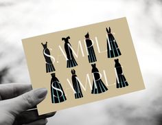 a person holding up a card with different dresses on it and the words small town written in white