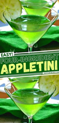 three martini glasses filled with green liquid and garnished with apple slices, sitting on a table