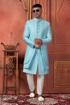 Look dapper on your wedding day with our beautifully crafted sky blue groom sherwani for men. This unique indo-western sherwani features intricate embroidery, perfect for grooms and their men. Our custom sherwani is tailored to perfection, including options for plus sizes. Whether you're looking for a traditional sherwani or a modern twist with an indo-western style, this sherwani is ideal for Indian weddings and special occasions. Stand out in style and make a lasting impression with our premiu Fitted Sherwani With Dabka For Wedding, Fitted Sherwani With Pallu For Groom, Fitted Sherwani For Groom At Festivals, Fitted Long Sherwani For Groom, Bollywood Style Fitted Sherwani For Groom, Fitted Sherwani For Groom, Diwali Festival, Fitted Sherwani For Groom Diwali Celebration, Fitted Long Bandhgala For Groom, Groom's Fitted Sherwani With Cutdana