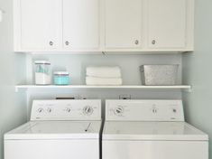 a white washer and dryer sitting next to each other in a laundry room