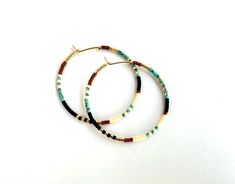 Large, hand-beaded boho-style hoop earrings. Very light weight.  4 beautiful color combinations to choose from. Made with very high quality Japanese beads. Gold plated, 1.5 inch hoops.  🌎 Packaging 🌎 To be environmentally responsible about packaging we will package orders together in the same box. If certain items in your order are intended as gifts and you'd like individual boxes, please leave a note during checkout. To view more items from this shop, click the link below:  https://www.etsy.c Package Orders, Seed Bead Hoop Earrings, Hoop Earrings Large, Bead Hoop Earrings, Japanese Beads, Grand Rapids Mi, Beautiful Color Combinations, Large Hoop Earrings, Beaded Hoop Earrings