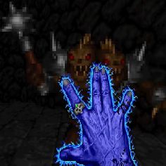 a hand with blue paint on it is in front of a stone wall and dark background