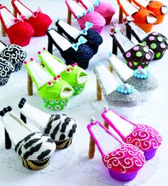 there are many cupcakes that have been decorated with different colors and designs on them