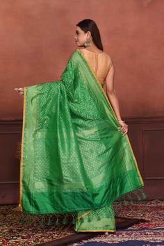 Radiate elegance on festive occasions in this beautiful green Katan silk Banarasi saree with over all zari work. The saree has yellow edging. It comes with a matching blouse piece. Disclaimer: The shown stitched blouse on the model is for display purpose only. The saree comes with a matching blouse piece and finished with fall and piko Disclaimer: The actual product may vary slightly from the image. These are custom orders, hence expect slight variation in color, placement of the motif or buta. Green Semi-stitched Pre-draped Saree With Meenakari, Festive Green Pre-draped Saree With Zari Weaving, Green Paithani Silk Pre-draped Saree With Self Design, Green Dola Silk Pre-draped Saree With Dupatta, Green Pre-draped Saree With Zari Weaving For Diwali, Green Bollywood Pre-draped Saree With Meenakari, Festive Green Paithani Silk Pre-draped Saree, Green Chanderi Pre-draped Saree For Puja, Green Dola Silk Pre-draped Saree For Diwali