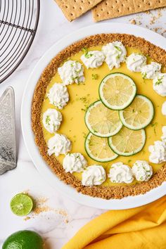 a lemon cucumber tart with whipped cream and lime slices in the middle