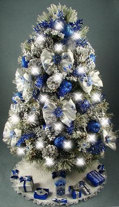 a decorated christmas tree with blue and silver decorations