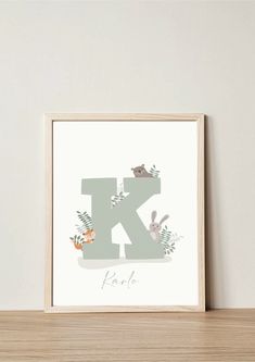 the letter k is made up of animals and plants on it's wall above a wooden shelf