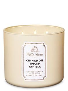 a white candle with cinnamon spiced vanilla inside