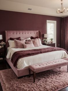 a bedroom with a large bed and pink carpeted area rugs on the floor