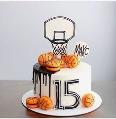 a birthday cake decorated with basketballs and the number fifteen on it's side