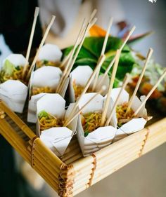 a tray filled with food and chopsticks on top of it