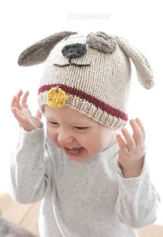 a baby wearing a knitted dog hat