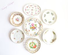 five plates with different designs on them sitting next to each other in the shape of flowers