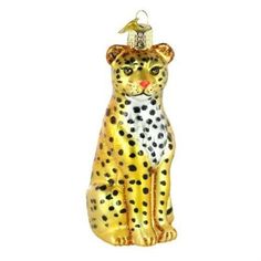 a glass ornament shaped like a cheetah with a hat on its head